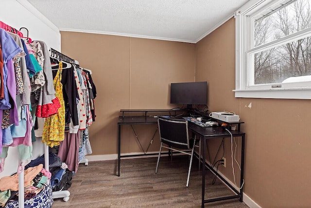 home office featuring a textured ceiling, baseboards, wood finished floors, and crown molding