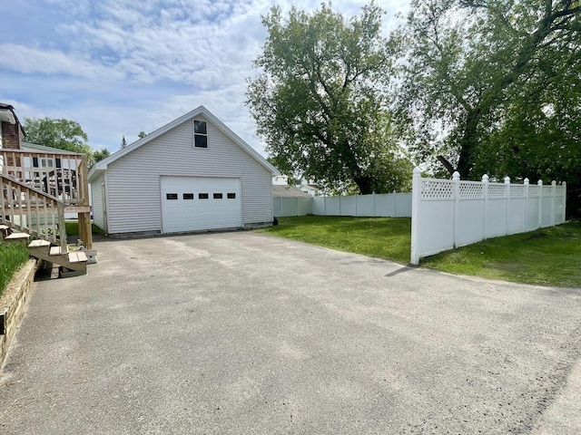 detached garage with driveway and fence