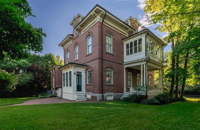 exterior space featuring a lawn and brick siding