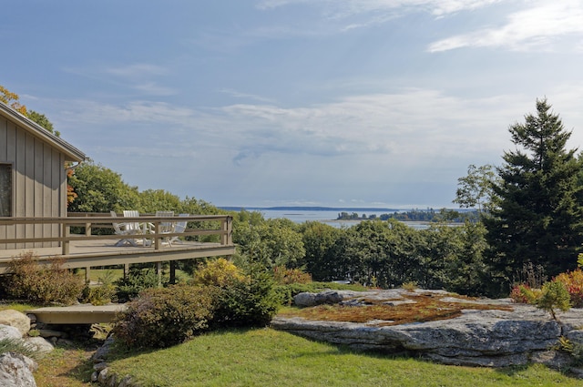 view of yard featuring a deck with water view