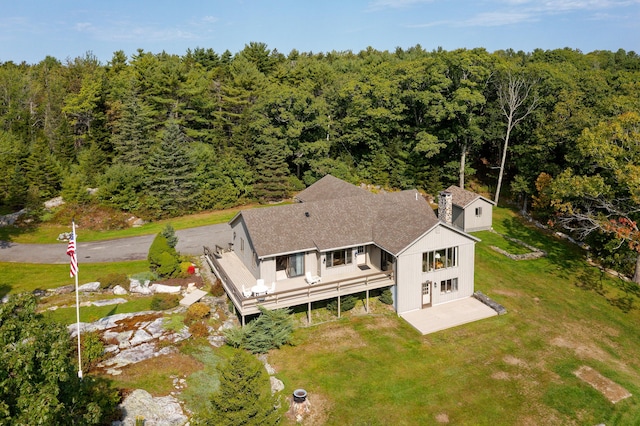 birds eye view of property with a wooded view