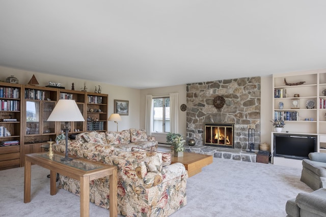 carpeted living room with a stone fireplace