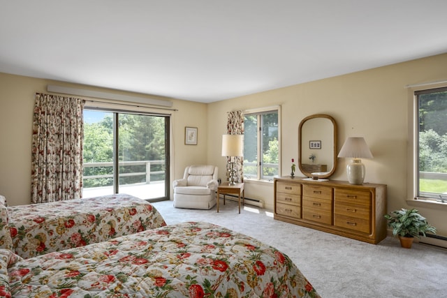 bedroom featuring access to outside, multiple windows, a baseboard radiator, and carpet floors