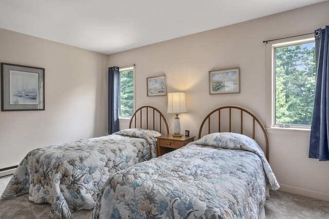 carpeted bedroom with multiple windows and baseboards