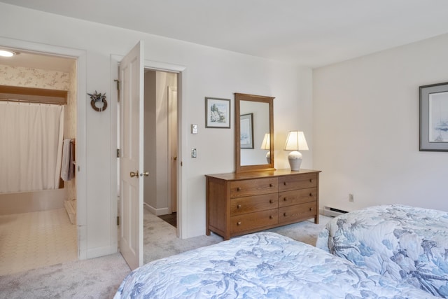 bedroom with light carpet, baseboards, and baseboard heating