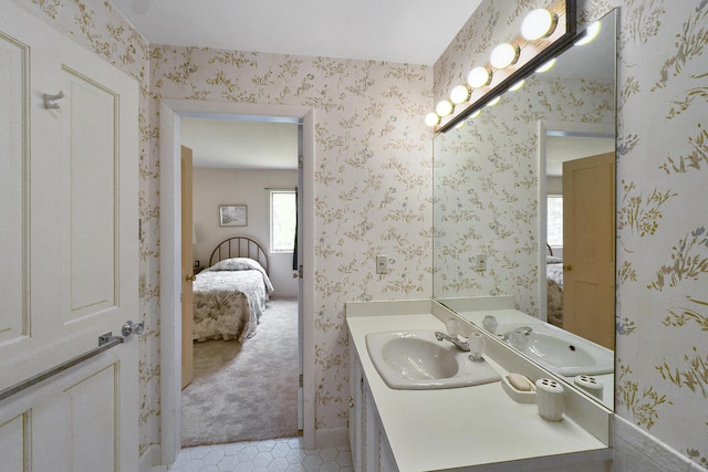 bathroom with wallpapered walls, tile patterned floors, vanity, and ensuite bathroom