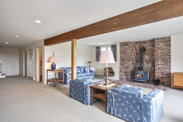 carpeted living area with a baseboard radiator, a wood stove, beamed ceiling, and recessed lighting