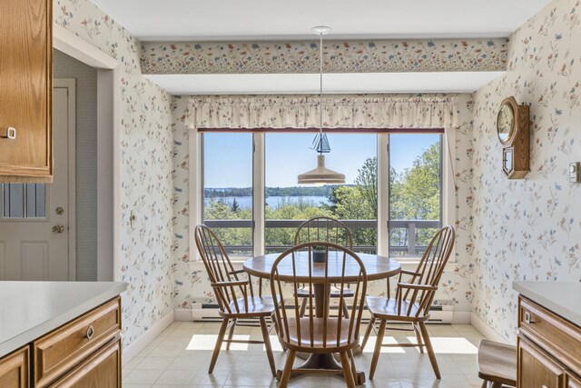 153 Back Shore Rd, Bristol, ME 04564 - dining area with wallpapered walls, healthy amount of natural light, light tile patterned flooring, baseboard heating, and baseboards