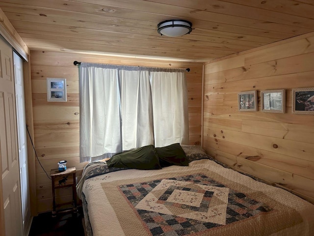 bedroom featuring wooden ceiling and wood walls