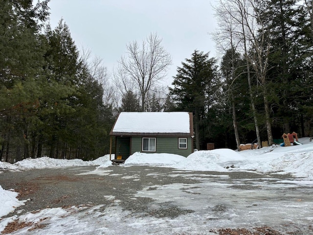 view of front of house with a view of trees