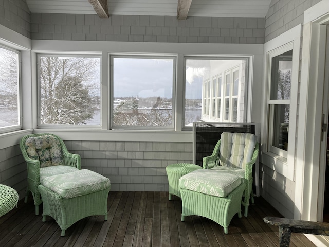 sunroom with beamed ceiling and a wealth of natural light