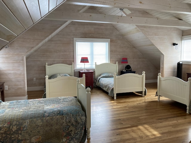 bedroom with lofted ceiling with beams, wood ceiling, wood finished floors, and wood walls