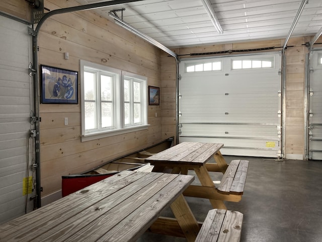 garage featuring wood walls