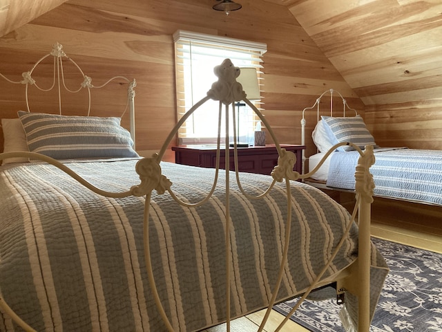 bedroom featuring lofted ceiling, wood ceiling, and wood walls