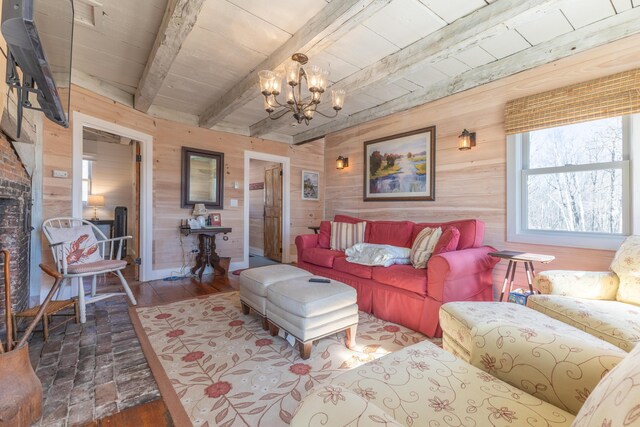 living room with a chandelier, beam ceiling, wood walls, and wooden ceiling