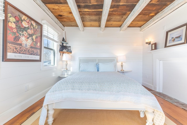 bedroom featuring wooden ceiling, beamed ceiling, and wooden walls