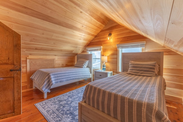 bedroom with wood-type flooring, wood ceiling, wood walls, and vaulted ceiling