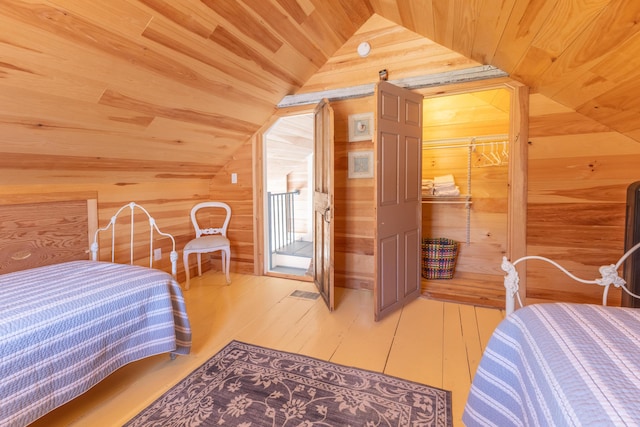 bedroom featuring wood finished floors, wood walls, lofted ceiling, wood ceiling, and access to exterior