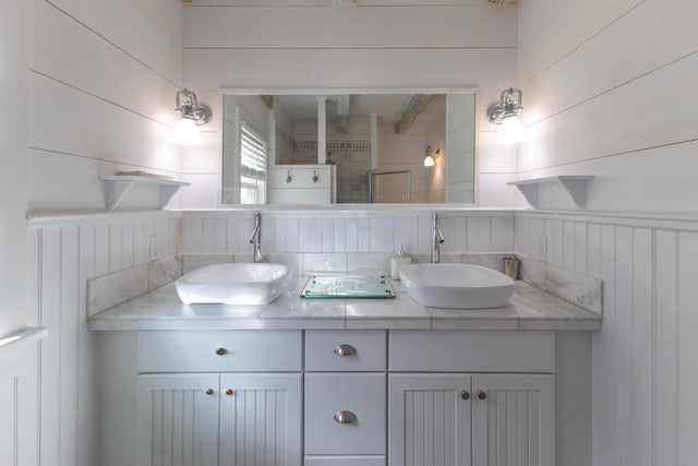 bathroom featuring double vanity and a sink