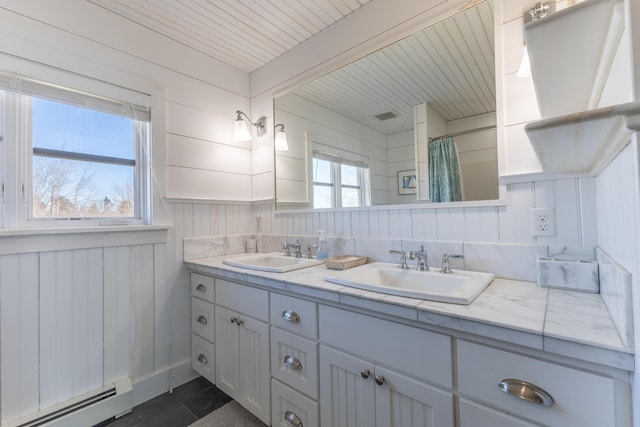 full bath with double vanity, a sink, a shower with curtain, and a baseboard radiator