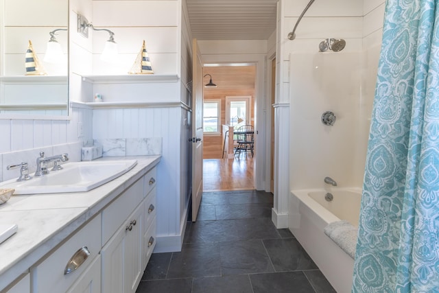 full bathroom featuring shower / bath combo with shower curtain and vanity