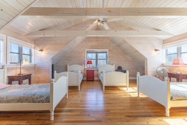 bedroom with multiple windows, wood-type flooring, wood ceiling, and vaulted ceiling with beams