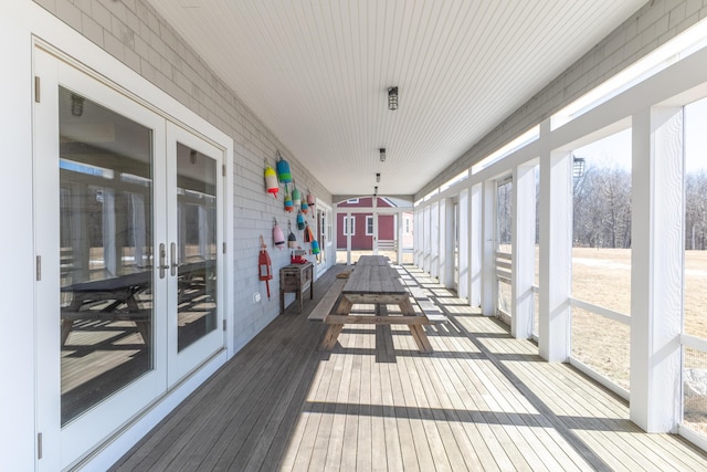 sunroom / solarium featuring a wealth of natural light and french doors