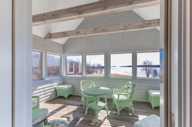 sunroom featuring lofted ceiling with beams