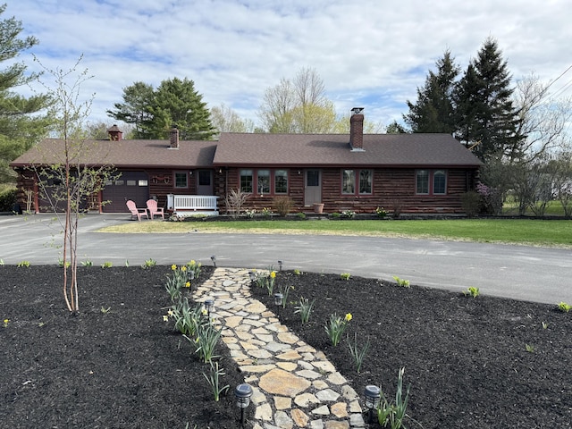 1 Angies Dr, Waterville, ME 04901 - view of front of home featuring a chimney, driveway, a garage, and log siding
