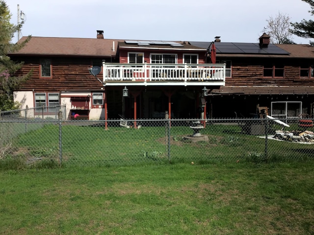 1 Angies Dr, Waterville, ME 04901 - rear view of property featuring a lawn, a deck, solar panels, and log siding