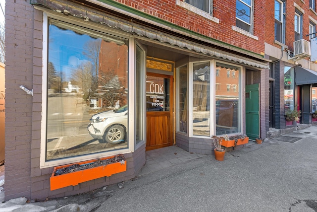 property entrance featuring brick siding