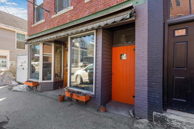 property entrance featuring brick siding