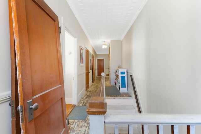 hallway featuring ornamental molding