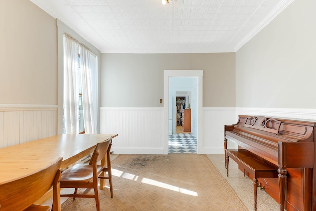 dining room featuring a wainscoted wall and ornamental molding