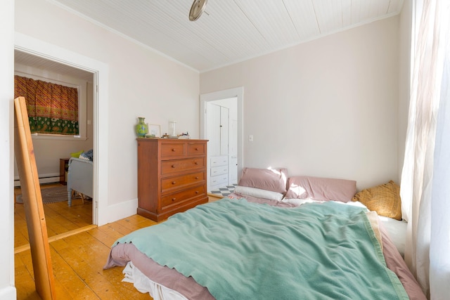 bedroom featuring light wood-style floors and ornamental molding