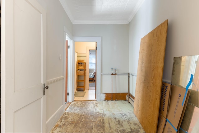 corridor featuring baseboard heating and crown molding