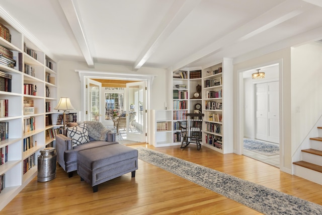 825 Hendricks Hill Rd, Southport, ME 04576 - sitting room with wood finished floors, beamed ceiling, and stairs