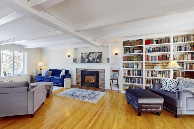 825 Hendricks Hill Rd, Southport, ME 04576 - living area with hardwood / wood-style flooring, beamed ceiling, and a fireplace