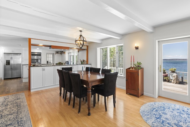 825 Hendricks Hill Rd, Southport, ME 04576 - dining space with beam ceiling, a chandelier, light wood-type flooring, and baseboards