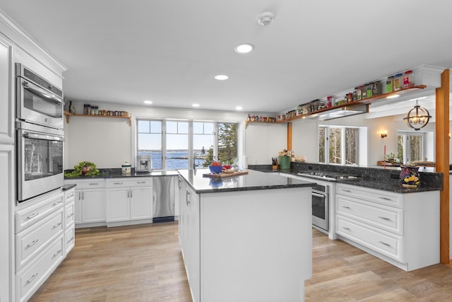 825 Hendricks Hill Rd, Southport, ME 04576 - kitchen with double oven, a kitchen island, white cabinetry, a peninsula, and recessed lighting