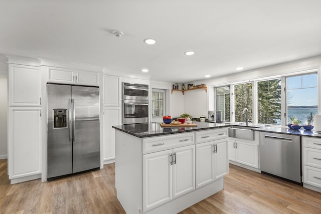 825 Hendricks Hill Rd, Southport, ME 04576 - kitchen featuring stainless steel appliances, a sink, a kitchen island, recessed lighting, and light wood-type flooring