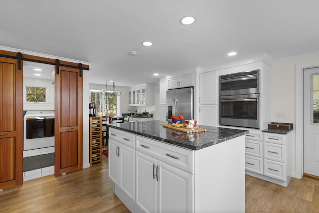 825 Hendricks Hill Rd, Southport, ME 04576 - kitchen featuring appliances with stainless steel finishes, light wood finished floors, recessed lighting, a barn door, and white cabinets