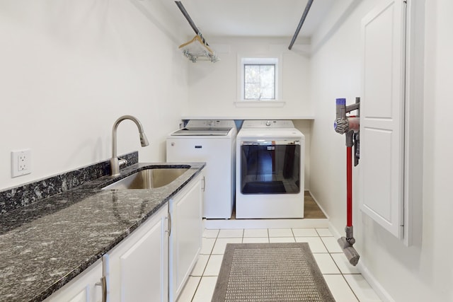 825 Hendricks Hill Rd, Southport, ME 04576 - laundry room featuring separate washer and dryer, cabinet space, and light tile patterned floors