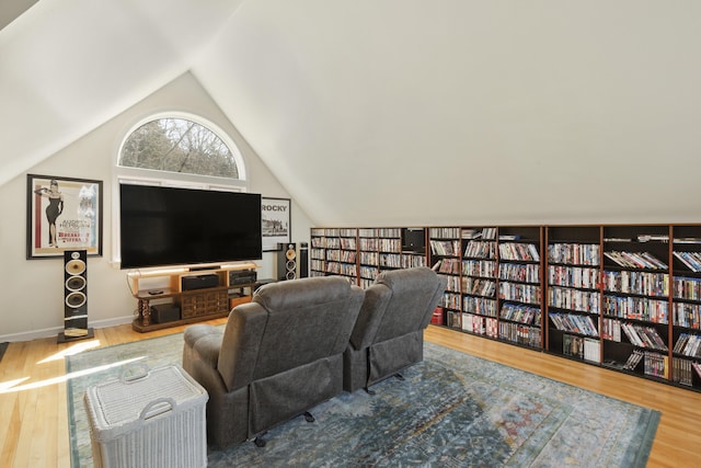 825 Hendricks Hill Rd, Southport, ME 04576 - living room featuring vaulted ceiling, wood finished floors, and bookshelves