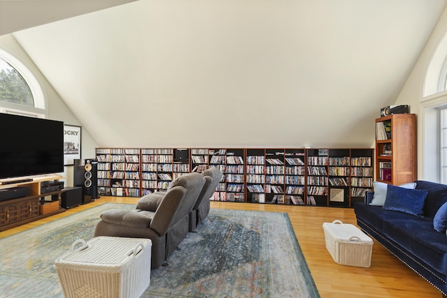 825 Hendricks Hill Rd, Southport, ME 04576 - living room featuring bookshelves, vaulted ceiling, and wood finished floors