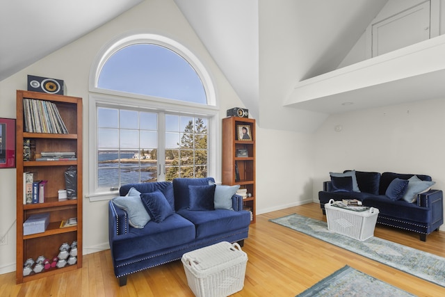 825 Hendricks Hill Rd, Southport, ME 04576 - living area with vaulted ceiling, wood finished floors, and baseboards