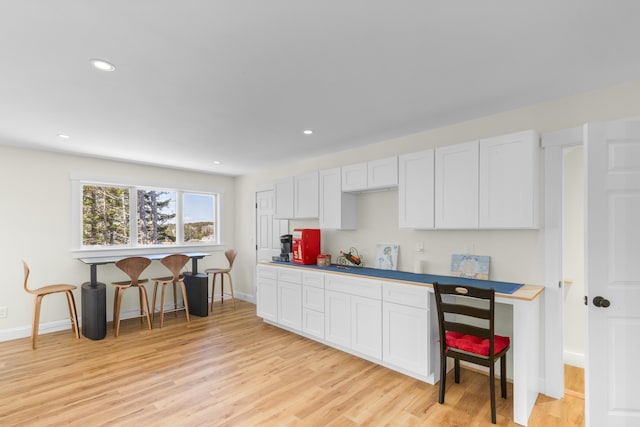 825 Hendricks Hill Rd, Southport, ME 04576 - kitchen featuring light wood-style flooring, baseboards, recessed lighting, and white cabinets