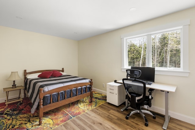 825 Hendricks Hill Rd, Southport, ME 04576 - bedroom featuring wood finished floors, baseboards, and a desk