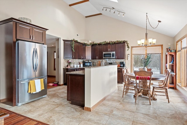 kitchen with dark brown cabinetry, decorative backsplash, stainless steel appliances, pendant lighting, and a notable chandelier