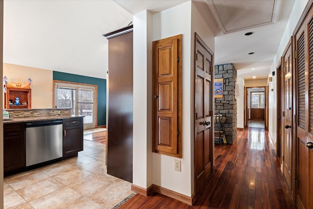 corridor featuring light wood-style floors and baseboards